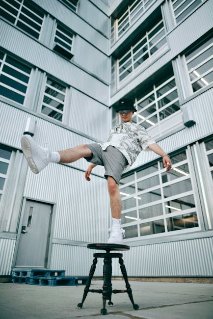 A focused person balancing on one leg in a well-lit space